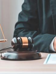 Man sitting at a desk with a Gavel